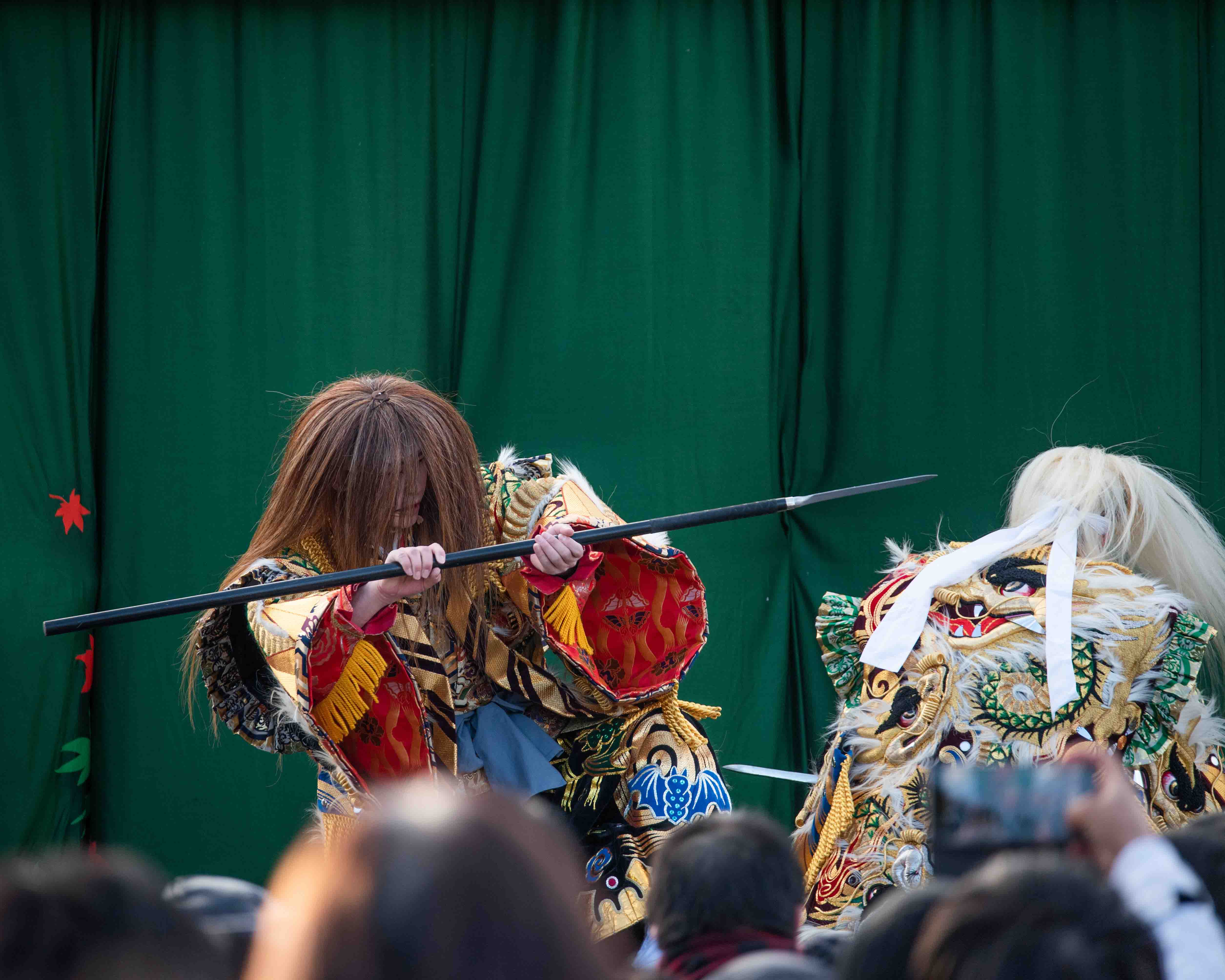 Traditional Japanese dancers perform acts to crowd, Miyajima Island